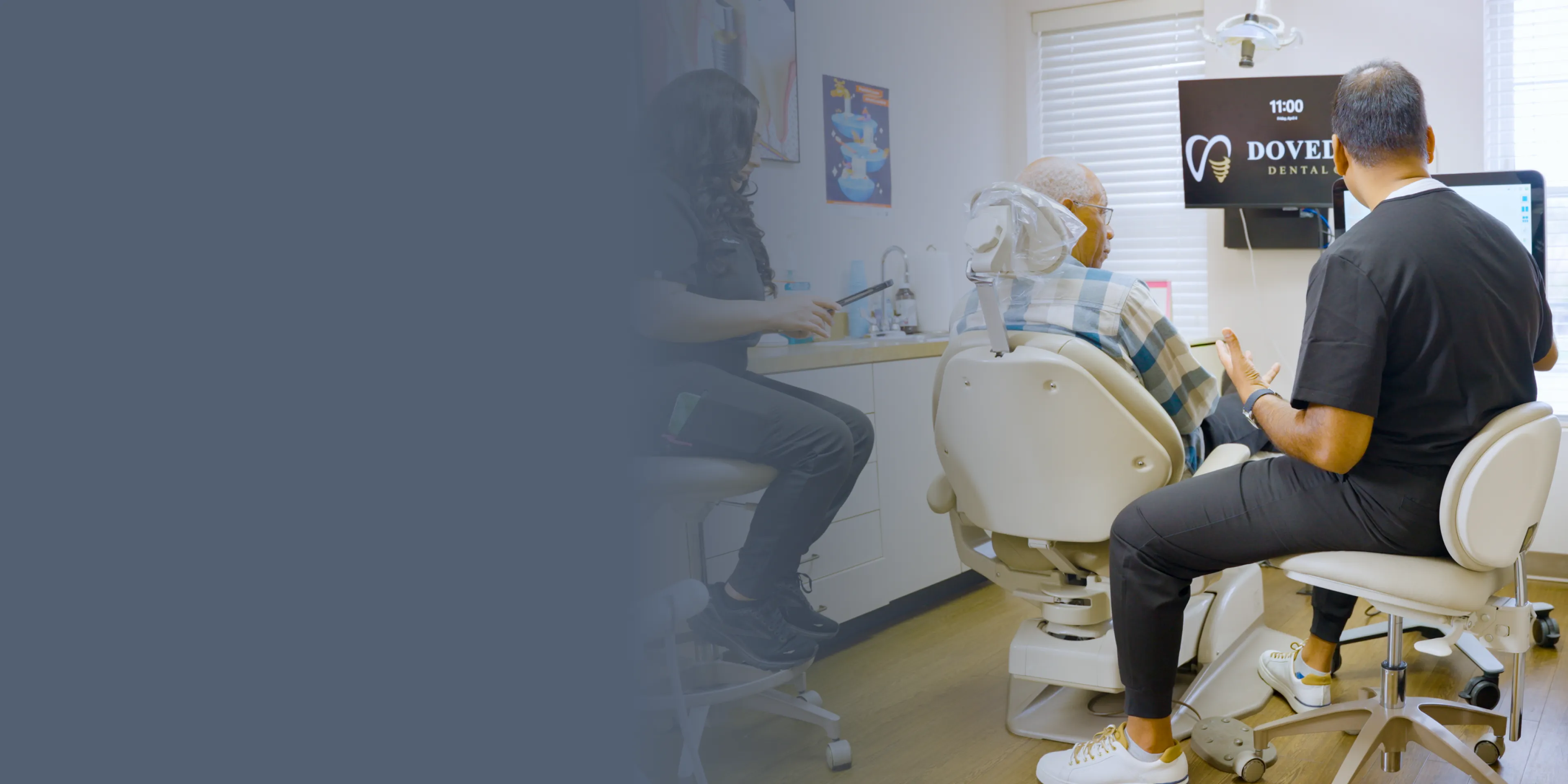 A woman looks concerned while another woman enthusiastically shows a dental model with teeth to her.