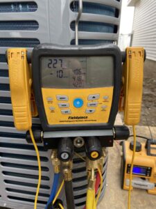 Shown is an AC refrigerant manifold and micron gauge, used by ProSolutions technicians to ensure your Air conditioning unit is properly started and balanced.