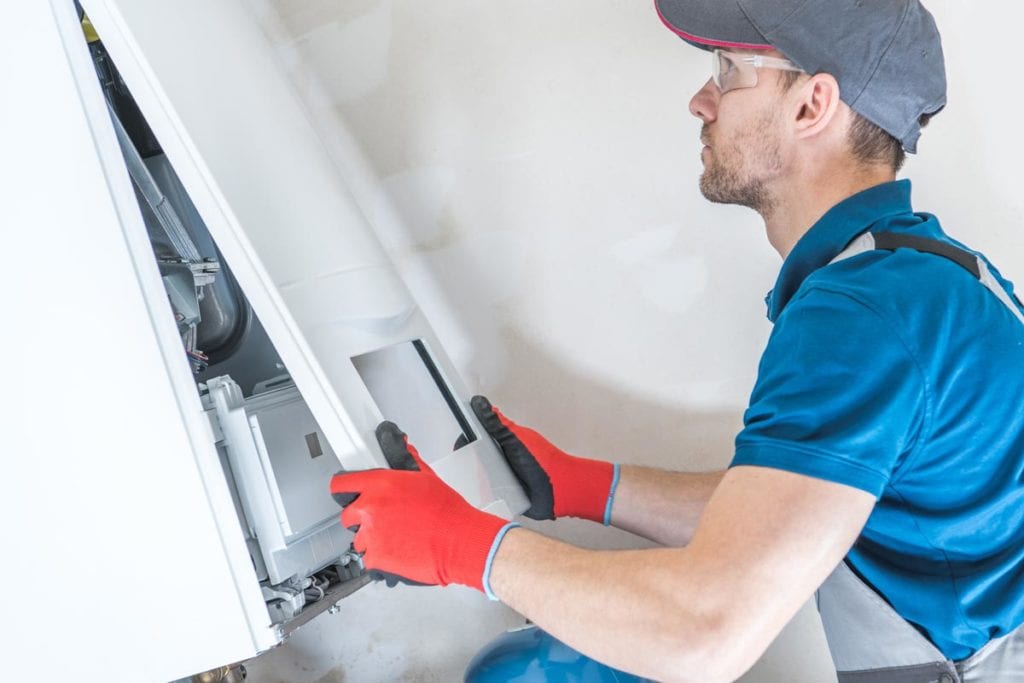 ProSolutions furnace technician installing new furnace in Edmonton home