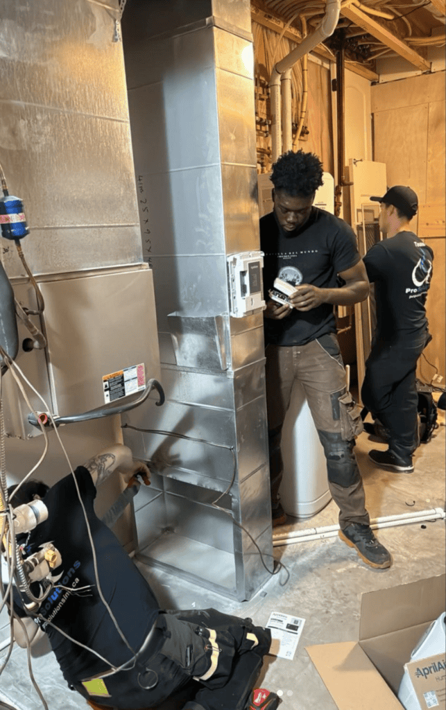 ProSolutions Inc. technicians installing a furnace in an Edmonton home