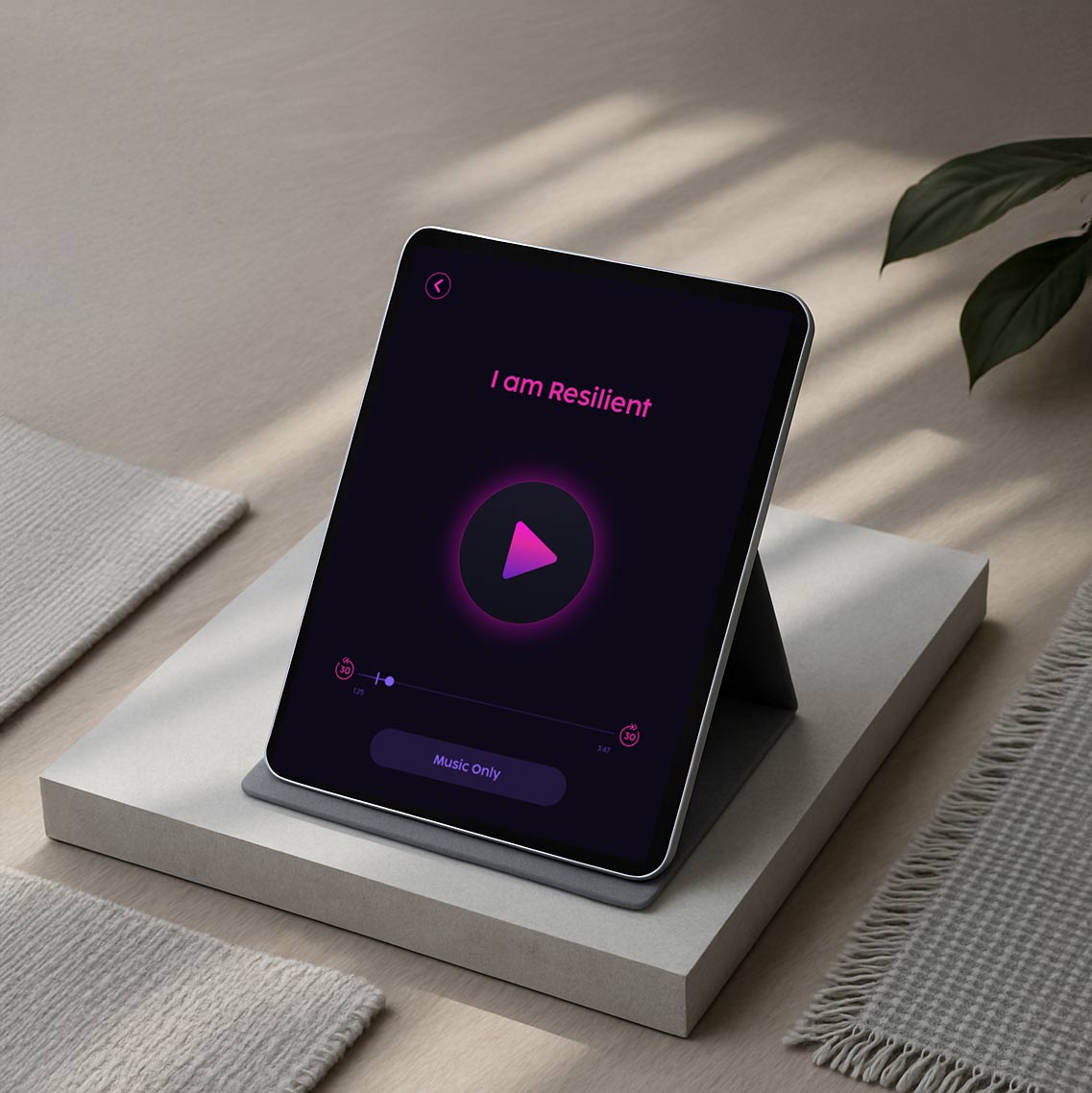 Tablet on a stand displaying Limitless Guided Visualizations app player with a pink play button and the title 'I am Resilient'.