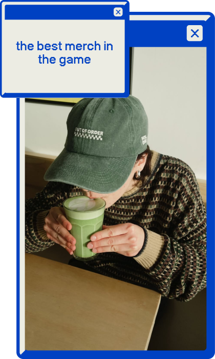 A photo of one of our staff members, in an Out of Order hat, drinking a matcha latte.