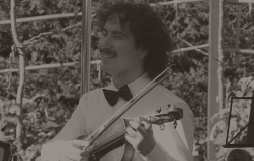 Edmund holding viola laughing.