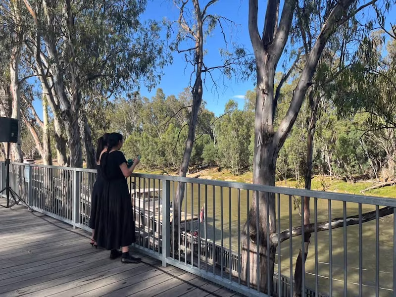 Two people looking out onto the Murray River. 