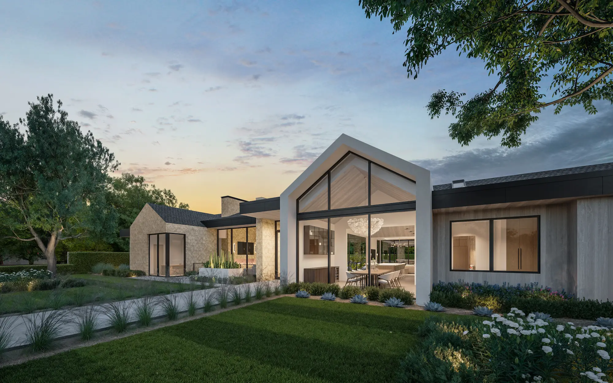 Modern single-story house with large windows, a gable roof section, and well-kept front yard at sunset.
