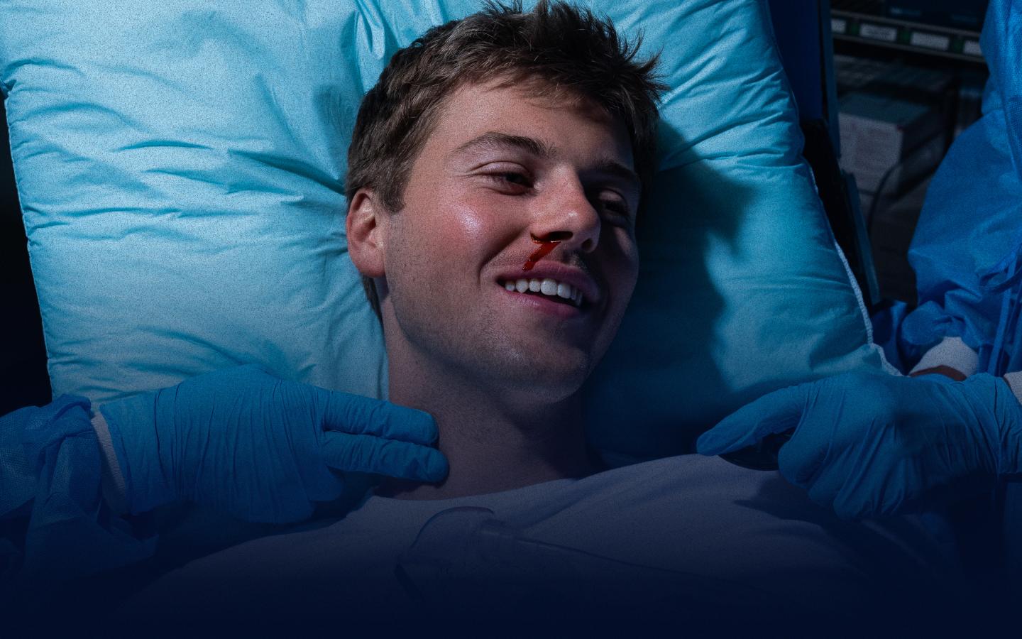Ruel lying in hospital bed with bleeding nose