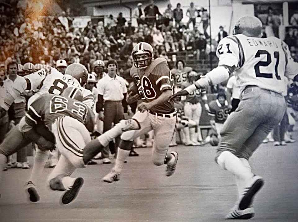 A football player running with the ball during a game