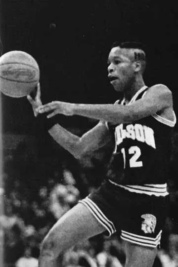 Basketball player wearing jersey number 12 passing the ball during a game.