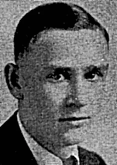 Black and white portrait of a man with short, neatly combed hair wearing a suit and tie.