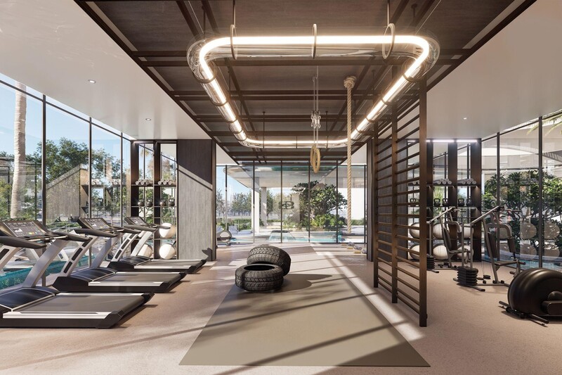 Gym in Dubai luxury apartment with city skyline through glass wall.