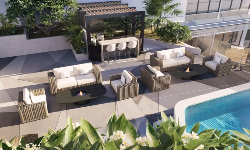 Rooftop infinity pool and wellness deck in luxury Arjan Dubai apartment building at sunset
