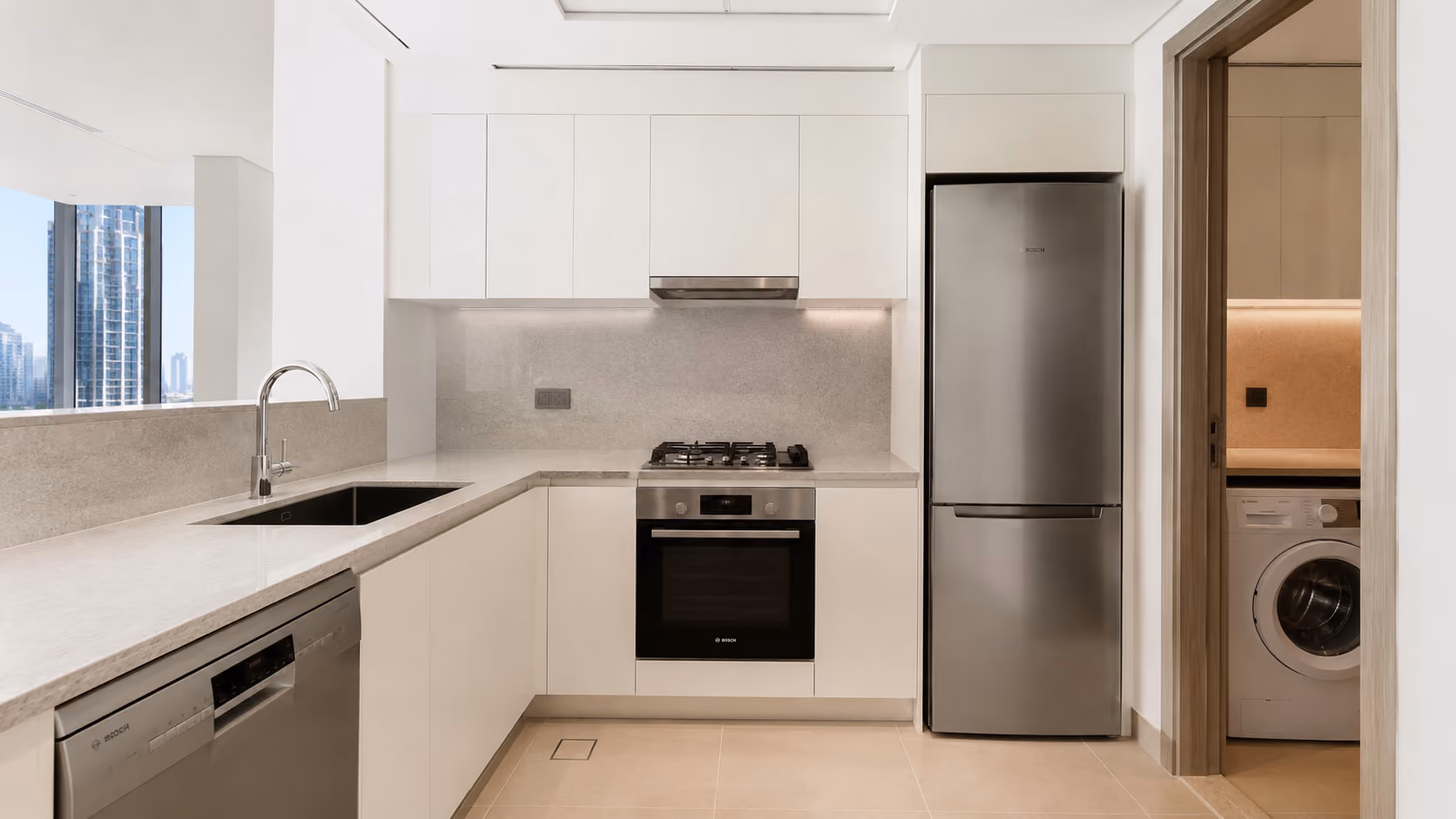 Modern Dubai apartment kitchen with full Bosch appliance package installed