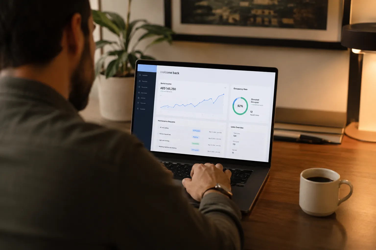 Investor reviewing Dubai property management dashboard on laptop showing rental income and maintenance data