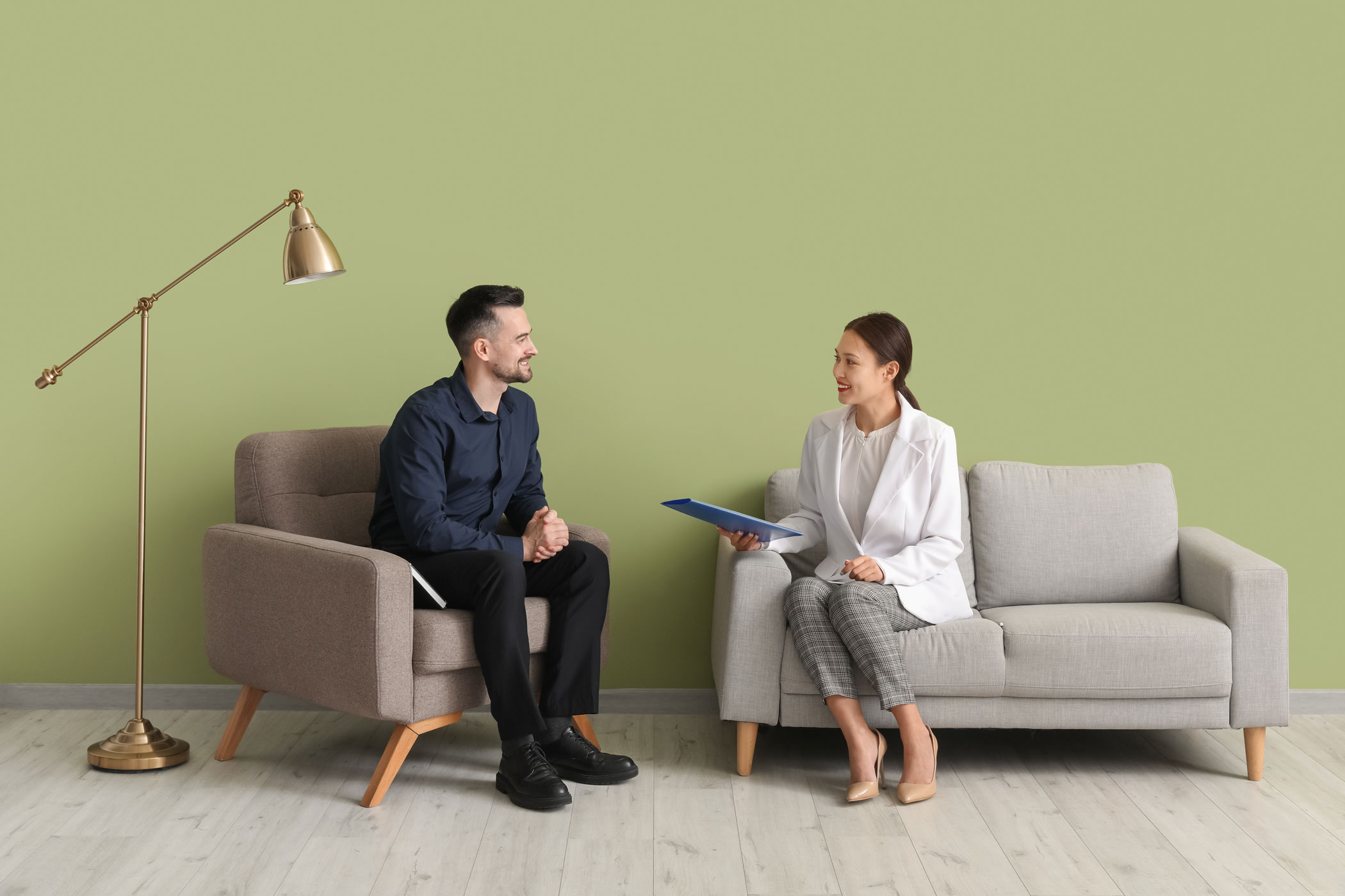 A Woman and Man on Chairs doing training for media interviews