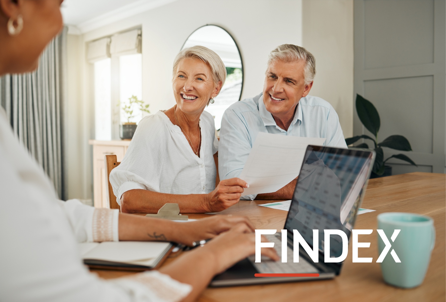 Image of elederly couple and a consultants having discussions at a dining table.