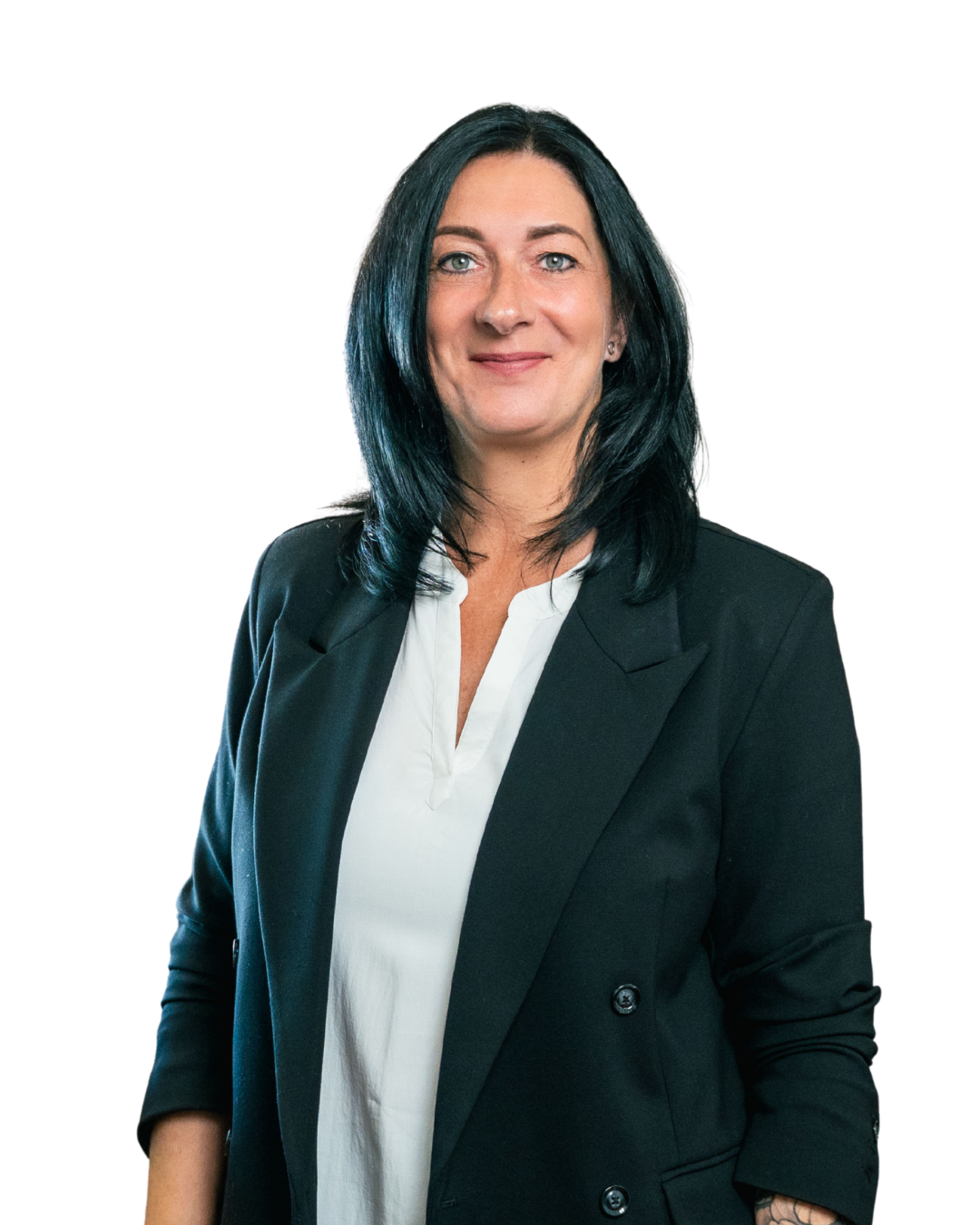 Smiling woman with black hair wearing a white blouse and black blazer against transparent background.