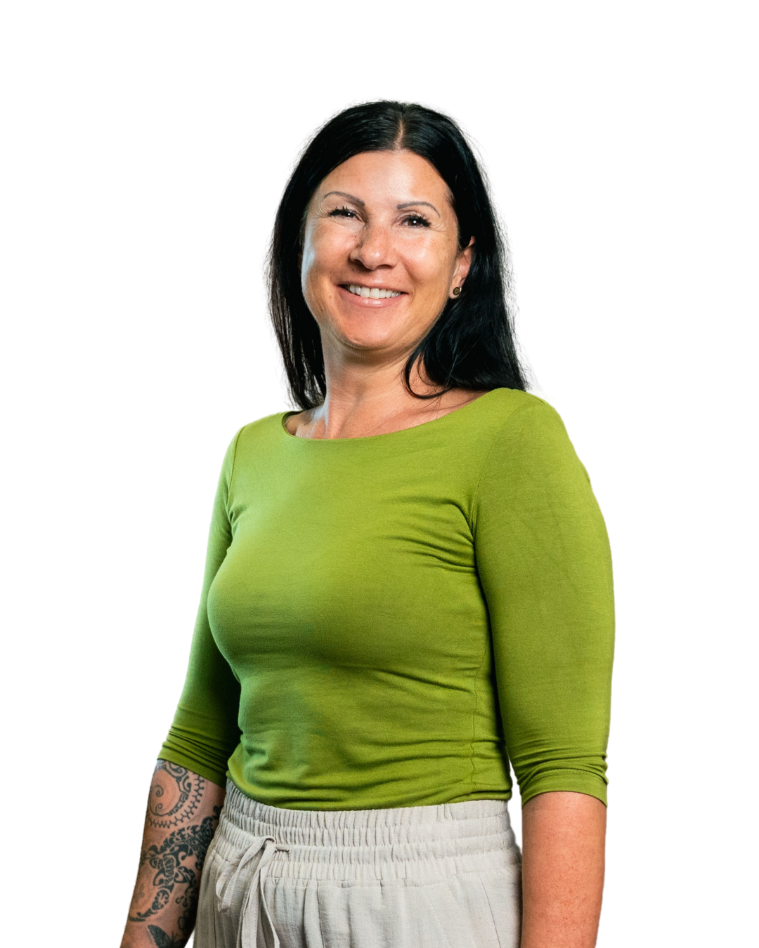Smiling woman with long black hair, green top, and tattoo on her left forearm.