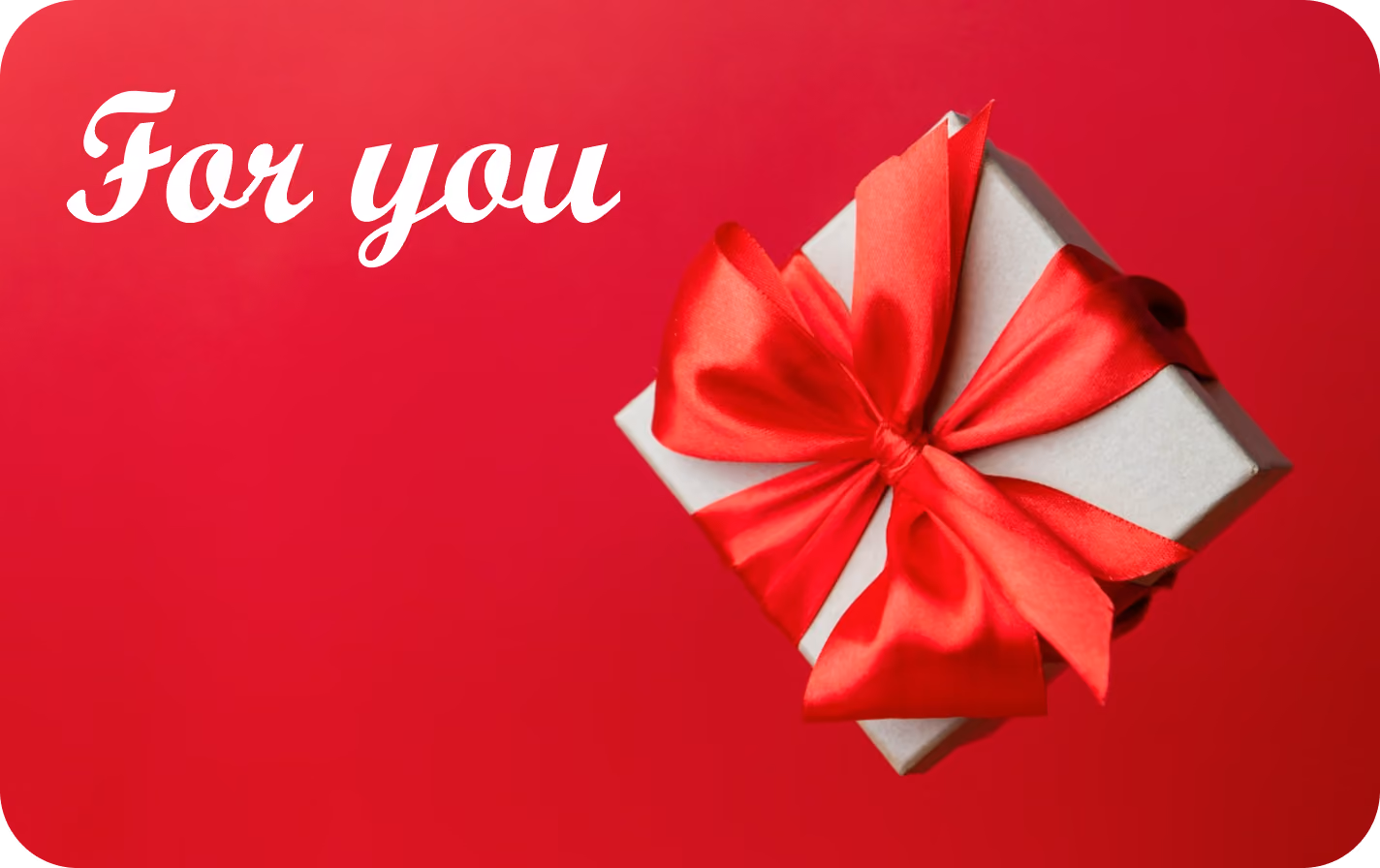 A small white gift box tied with a large red satin ribbon bow against a red background with the white text 'For you' in cursive font on the left.