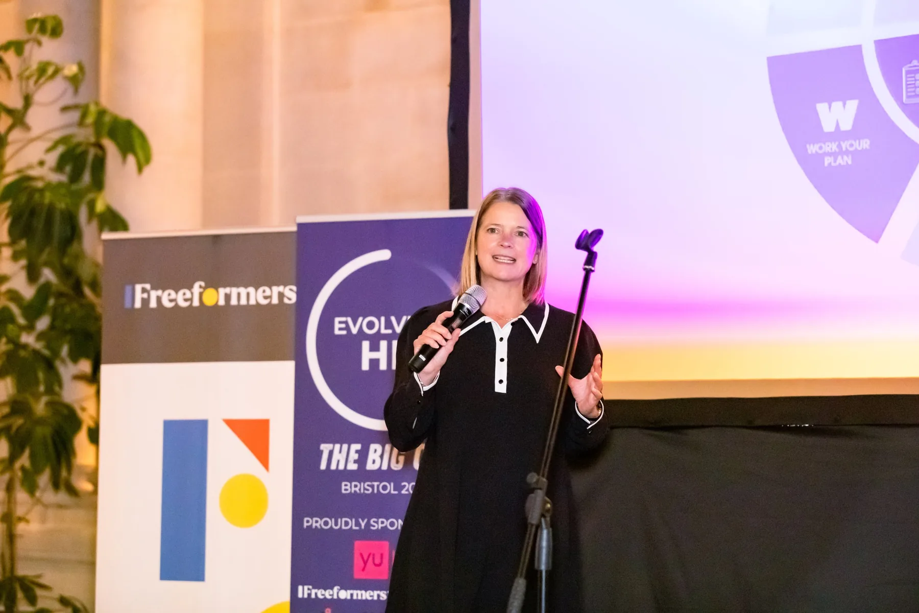 Niki Corbishley speaking on stage at an Evolve HR event in Bristol