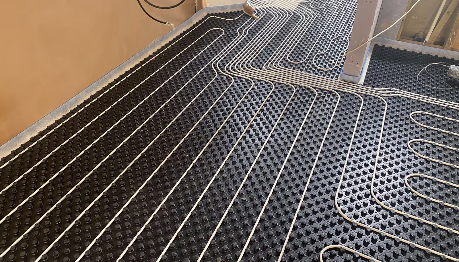 Underfloor heating installation in a Surrey home using energy-efficient systems.