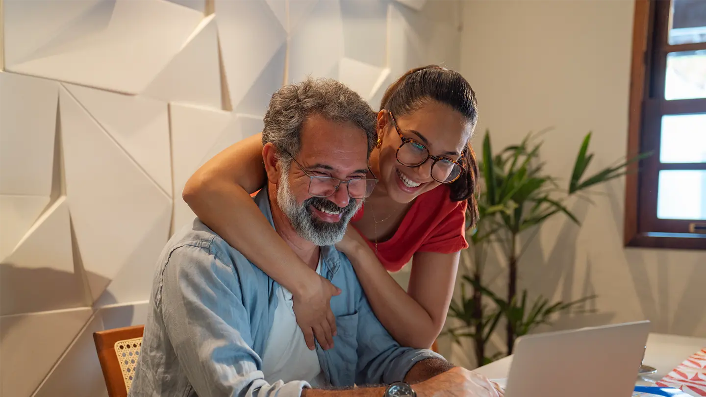 A father and older daughter on the computer seeing that IdentityIQ is now in spanish