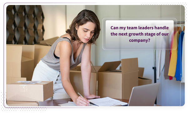 Scale-up founder packing boxes while wondering if her team leaders can handle the next growth stage of the company