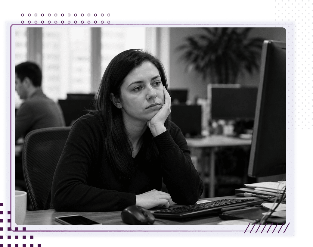 Disengaged employee at her desk illustrating the cost of low employee engagement