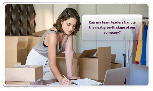 Scale-up founder packing boxes while wondering if her team leaders can handle the next growth stage of the company