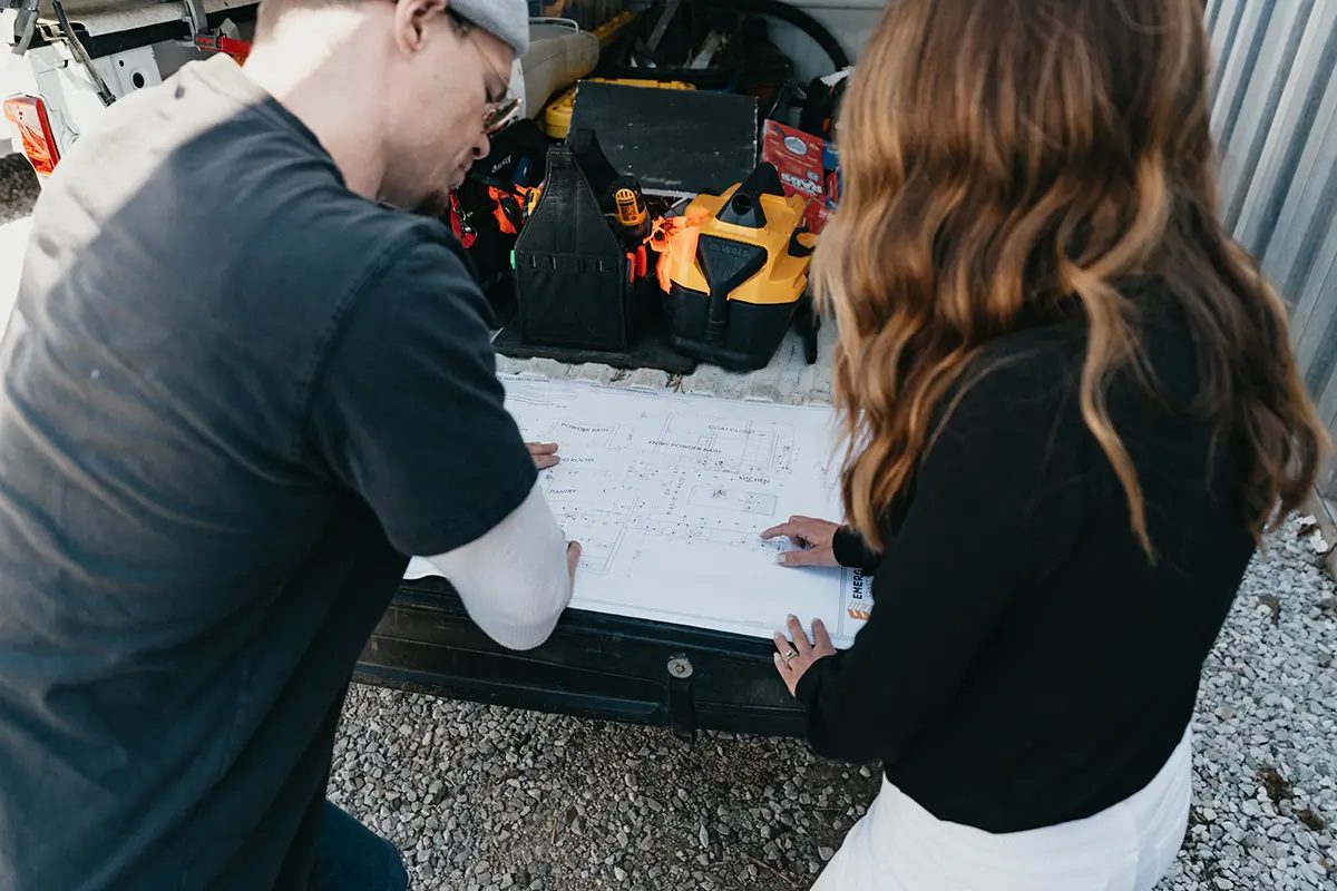 Jacob and Lori reviewing project blueprints