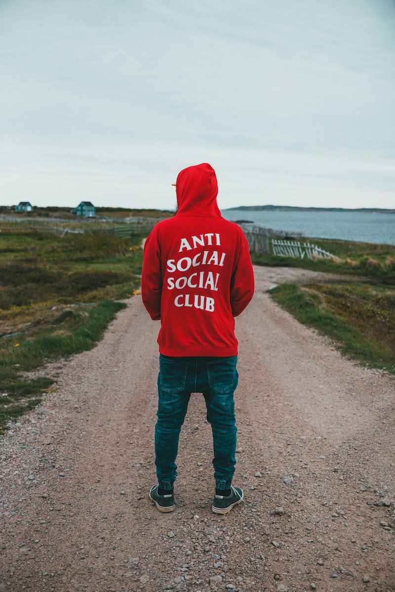 A man with a red swetashirt showing his back