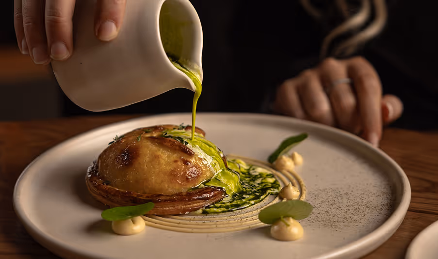 Family-style sunday roast with gravy jug and vegetables showcasing refined dining and modern Irish flavours at Neighbourhood in Kildare.