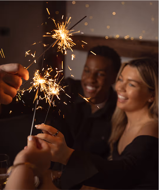 Guests raising glasses under christmas lights, captured at Neighbourhood — a refined christmas restaurant kildare experience in County Kildare.