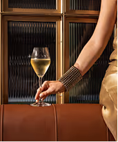 Wine glass raised against restaurant interior within Neighbourhood’s award-winning fine dining setting in Naas.