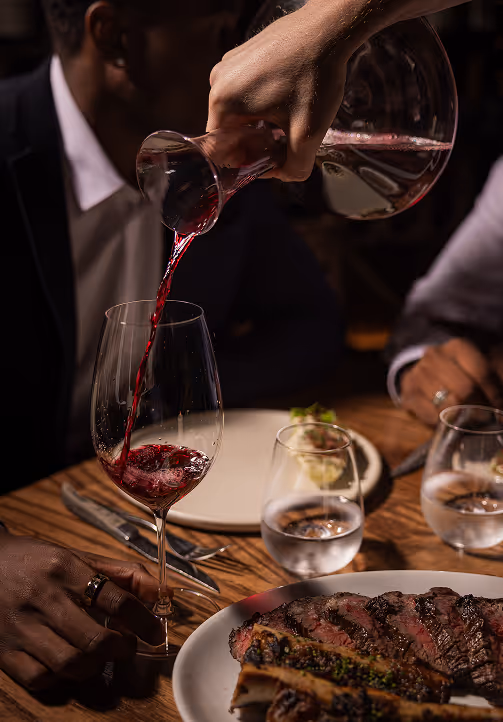 Waiter pouring wine at award-winning Neighbourhood Naas, the best restaurant in kildare