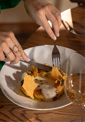 Fork cutting into plated main dish showcasing Neighbourhood’s modern Irish cuisine and refined atmosphere.