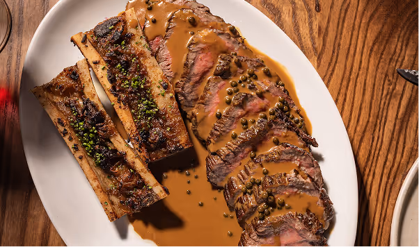 Sliced steak served with rich sauce showcasing refined dining and modern Irish flavours at Neighbourhood in Kildare.