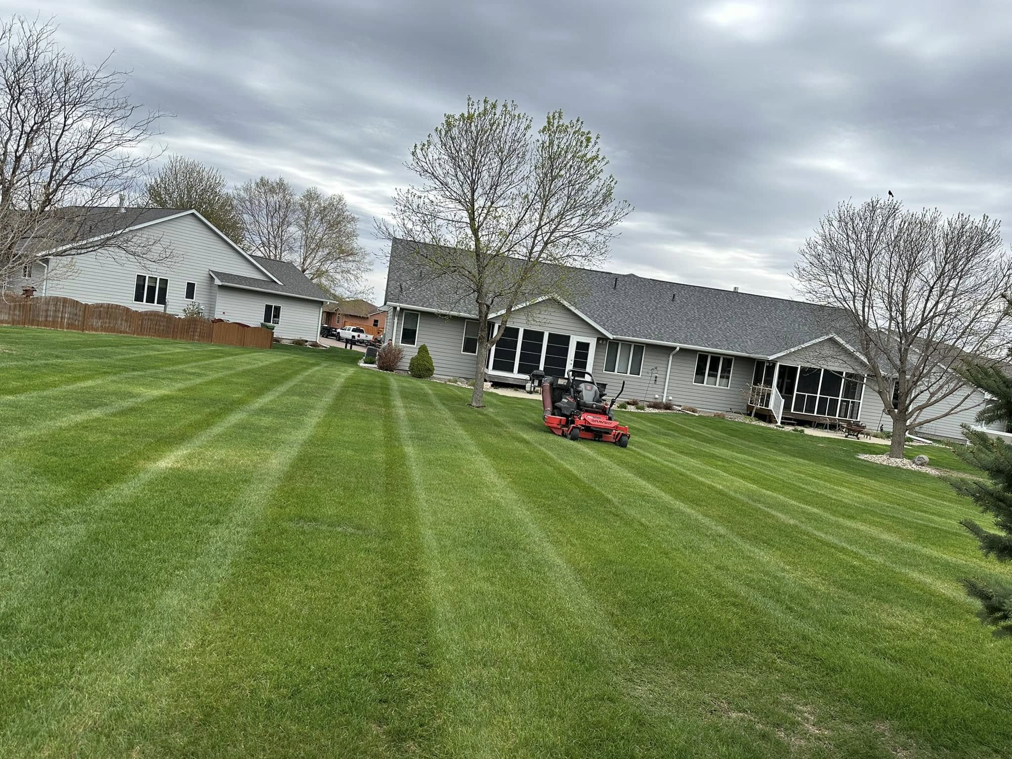 Photo of Property Care Pros mowing a residential lawn