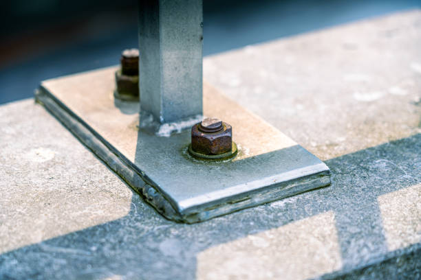 Close-up of heavy-duty brackets securing the frame beneath an elevated stone patio