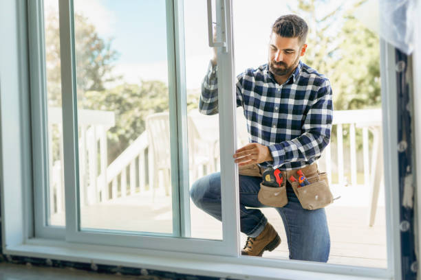 DIY homeowner measuring patio doorway for sliding patio screen door installation