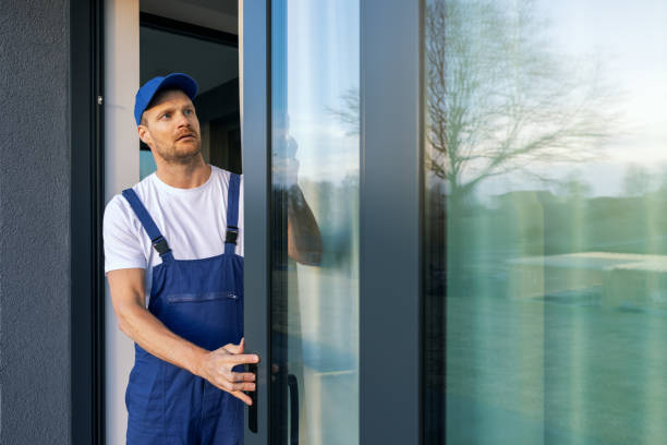 Contractor installing a wide patio door in a residential home during remodeling