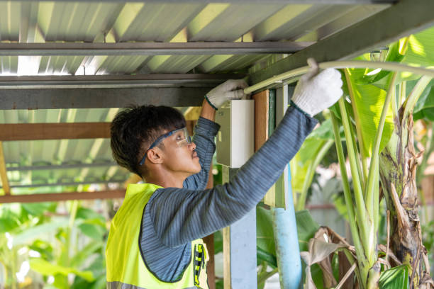Worker assembling metal frame for a budget-friendly patio enclosure project