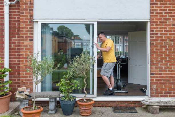 Sliding replacement patio door being carefully positioned into doorway