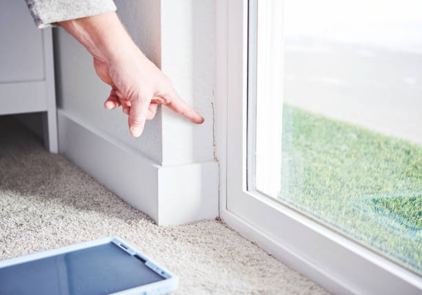 Homeowner inspecting sliding door frame for damage following door removal