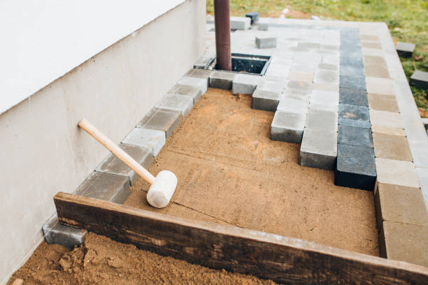 Detailed view of layering process from soil to paver placement on outdoor patio