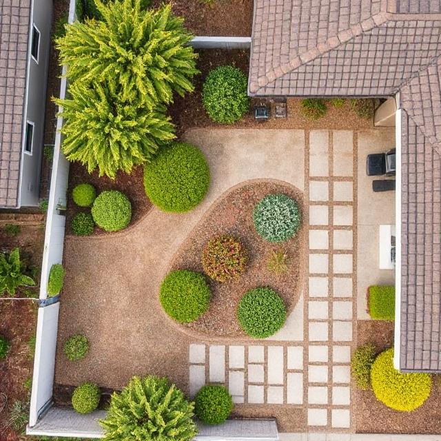 Aerial view of a California property showcasing zone 0 defensible space with pavers and trimmed vegetation