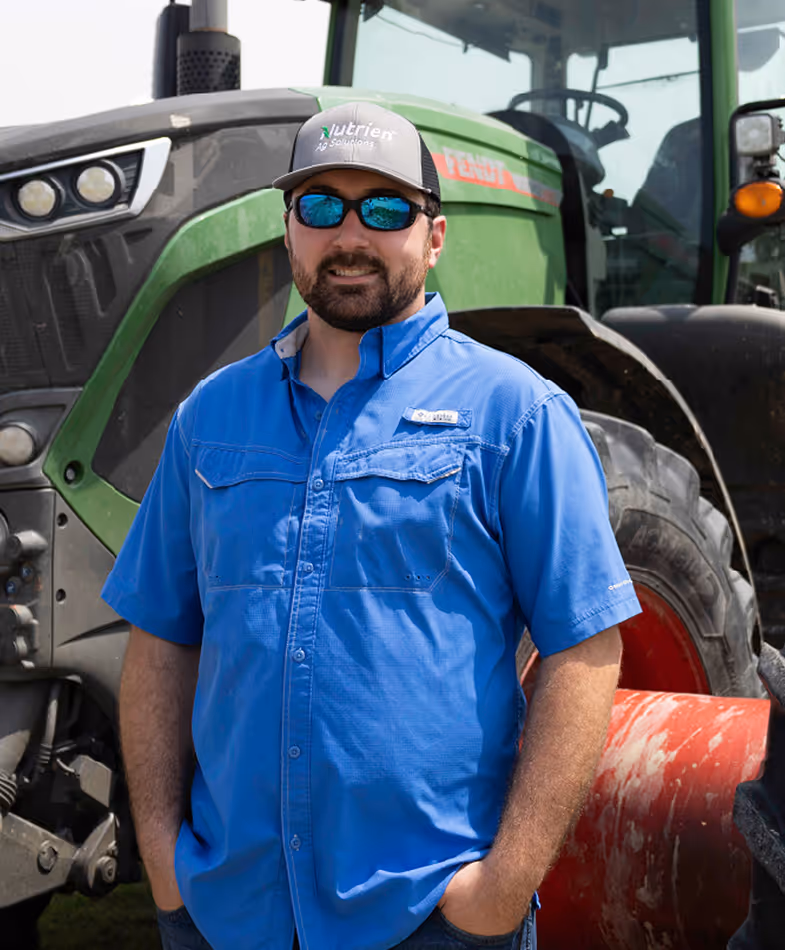 Lawson standing in front of a tractor.