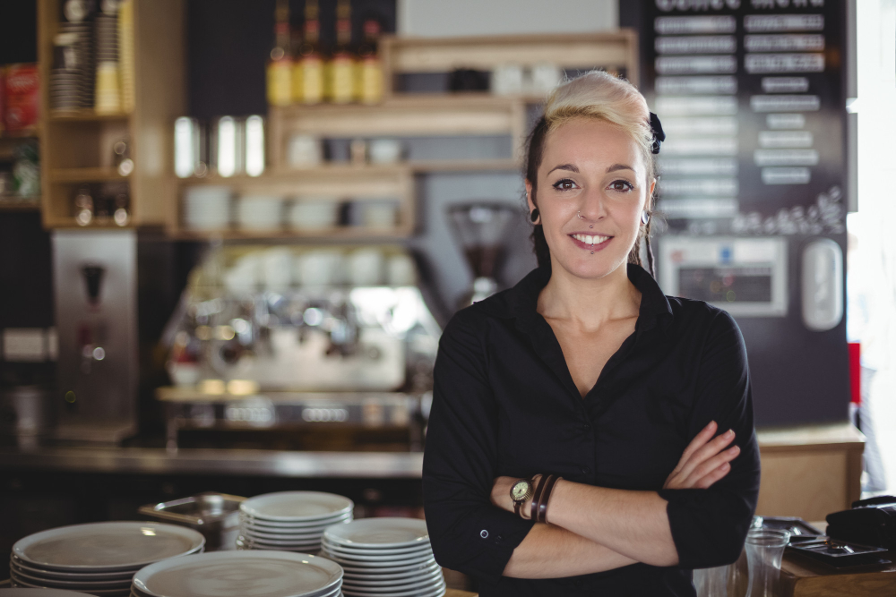 Business owner portrait image of her infront of her coffee shop bar