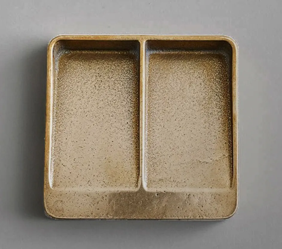A small tray with two compartments on it.