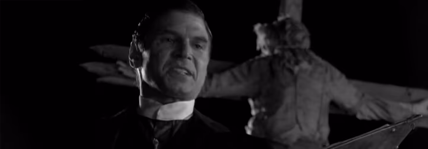 Black-and-white photo of a smiling man wearing a priest’s collar, with a woman in distress blurred in the background.