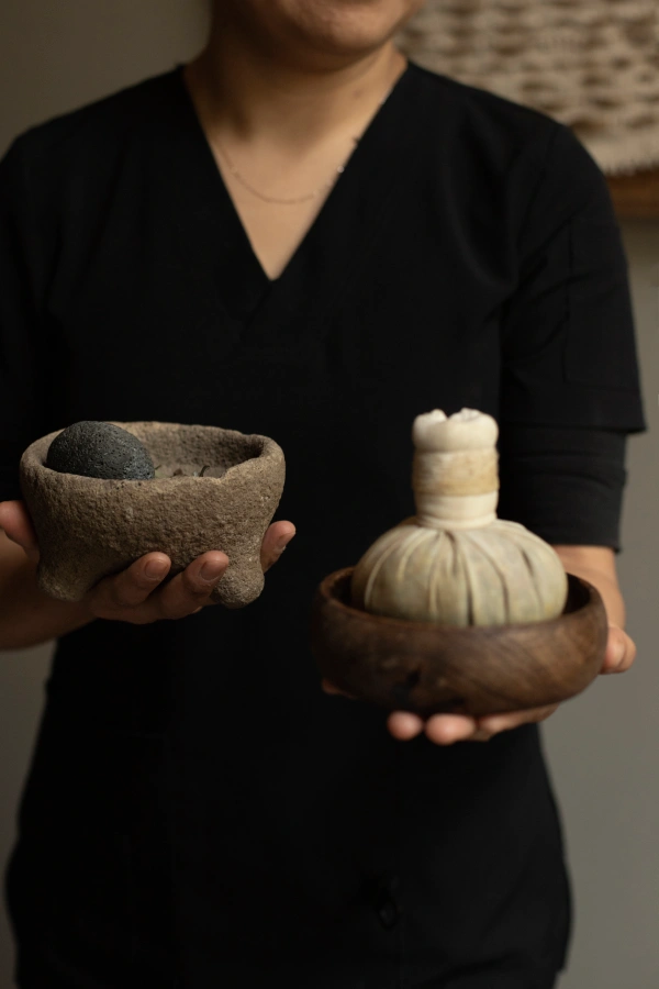 woman-performing-hot-stone-massage